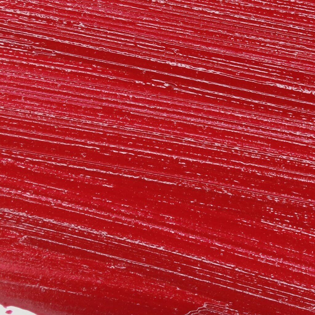 Close-up view of vibrant red Lip Fondant Liquid Lipstick texture with a smooth, matte finish.