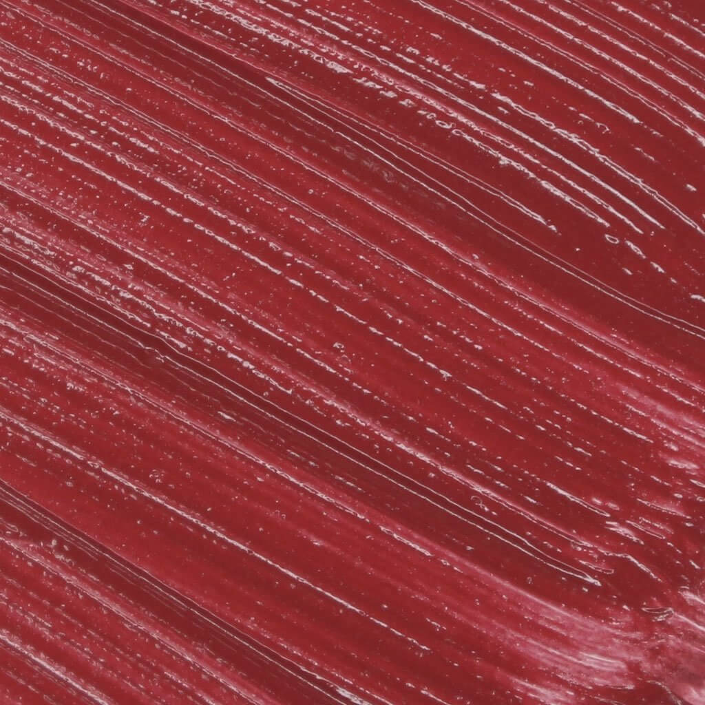 Close-up of Lip Fondant Liquid Lipstick in a vibrant deep red shade with a smooth, glossy texture.